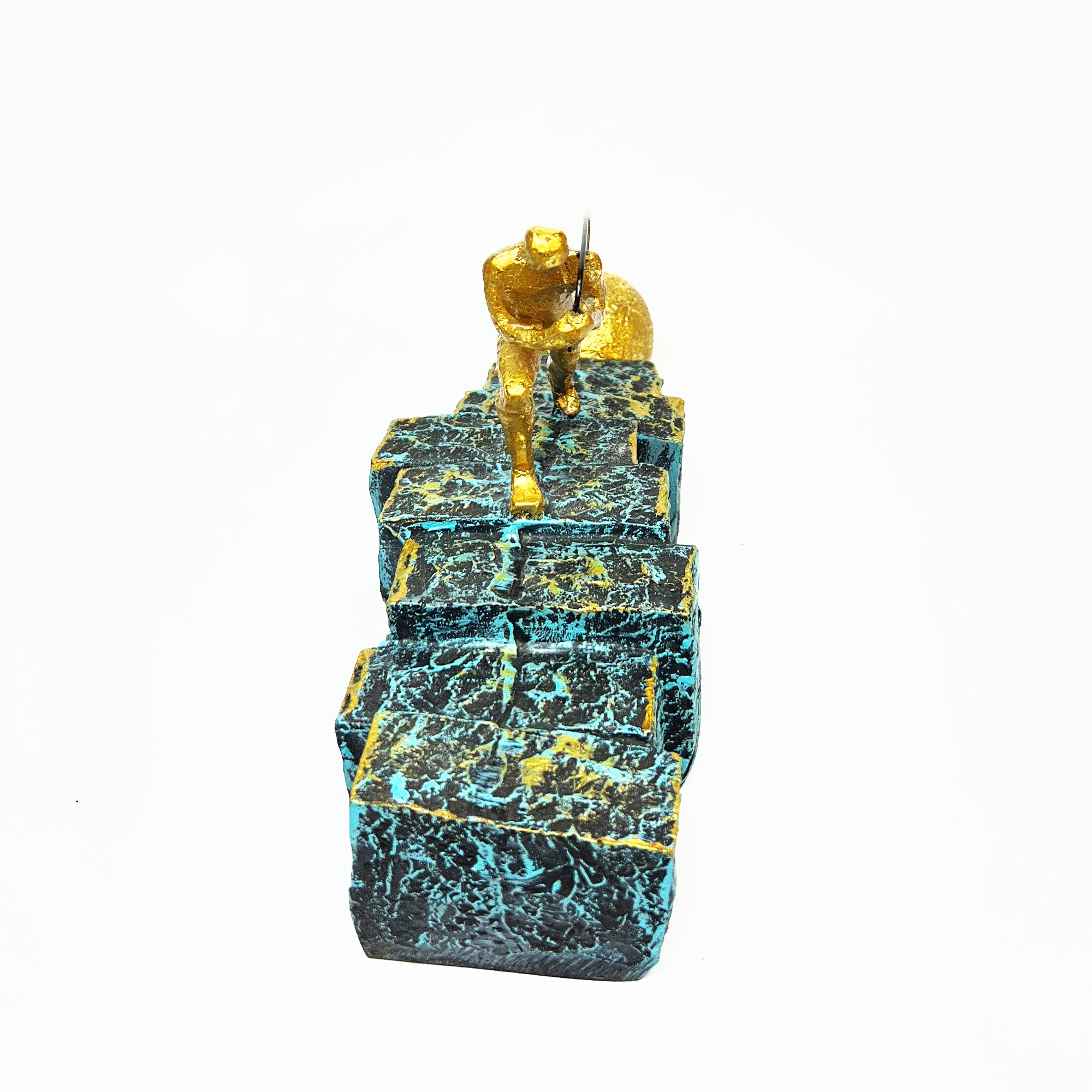 Golden Figurine Pulling Ball on Stairs