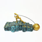 Golden Figurine Pulling Ball on Stairs