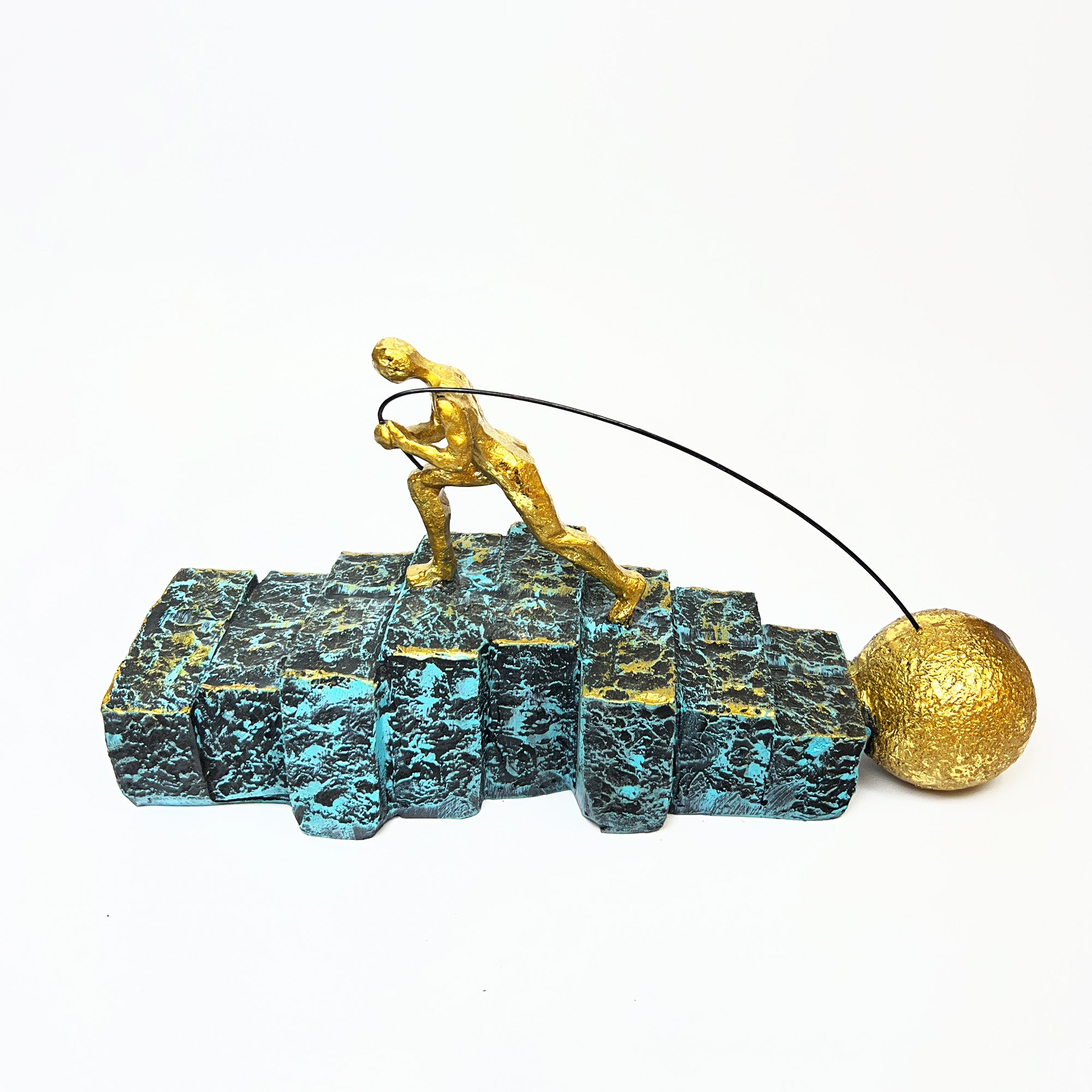 Golden Figurine Pulling Ball on Stairs