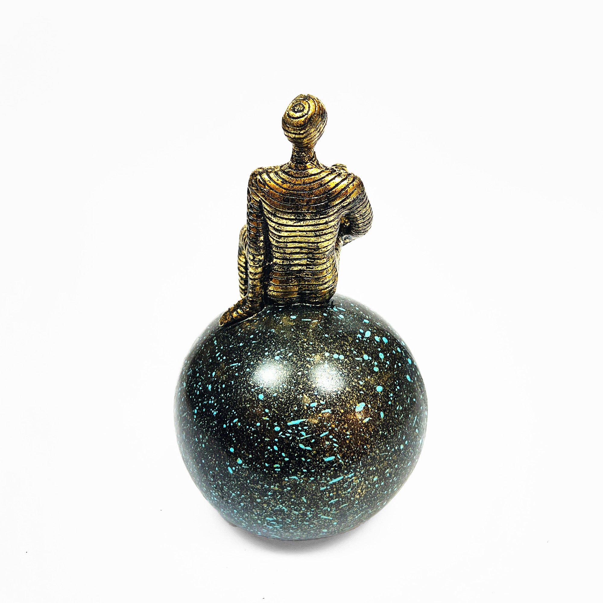 Golden Abstract Figurine Sitting on Globe