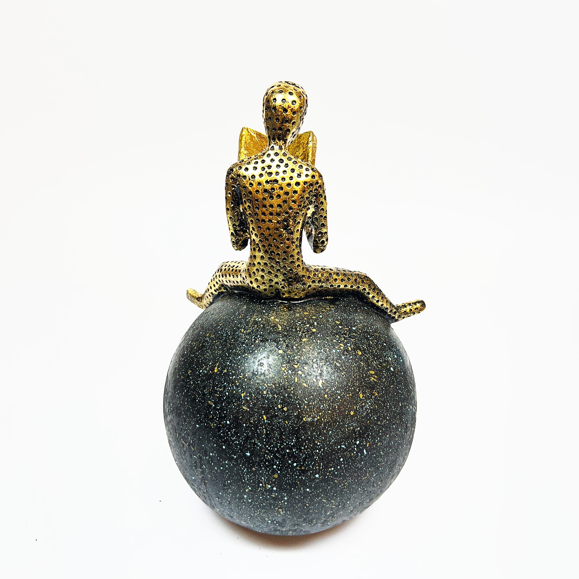 Golden Figurine Reading a Book on Globe