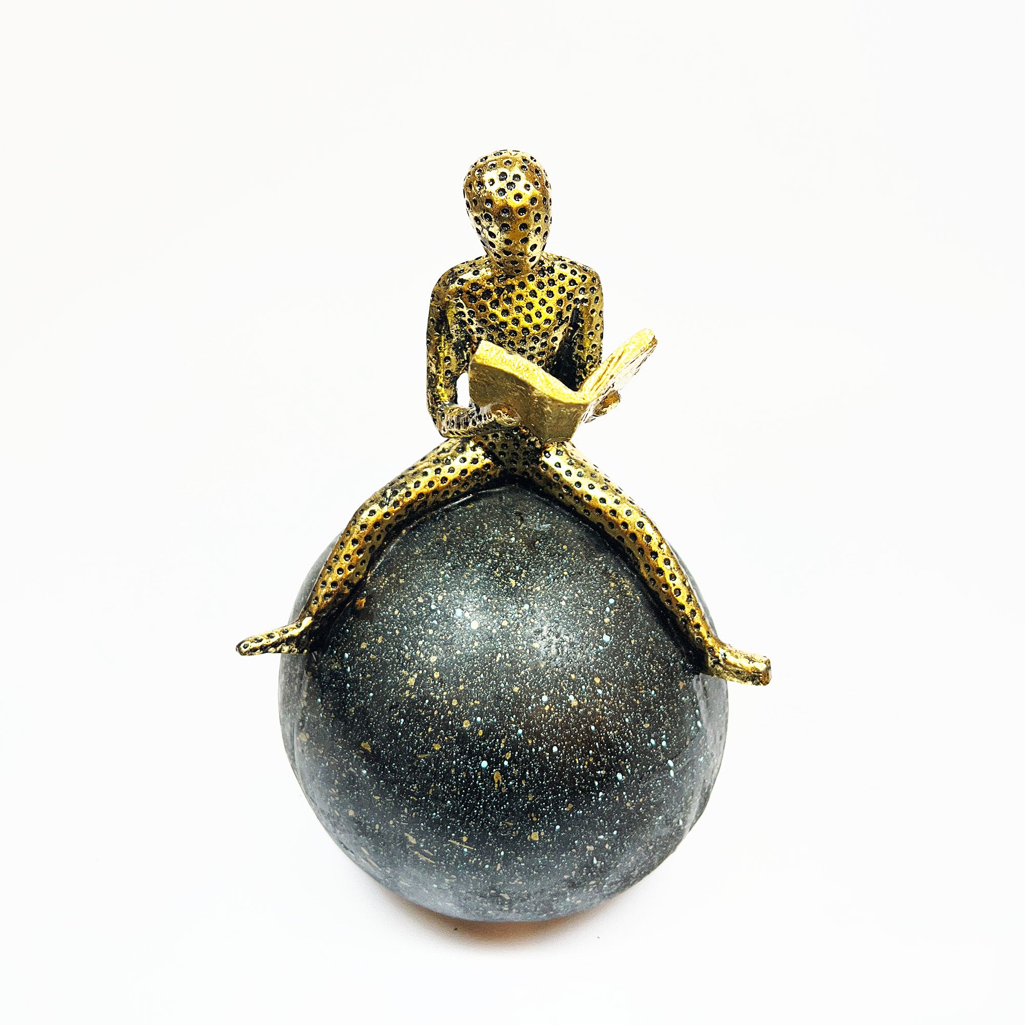 Golden Figurine Reading a Book on Globe