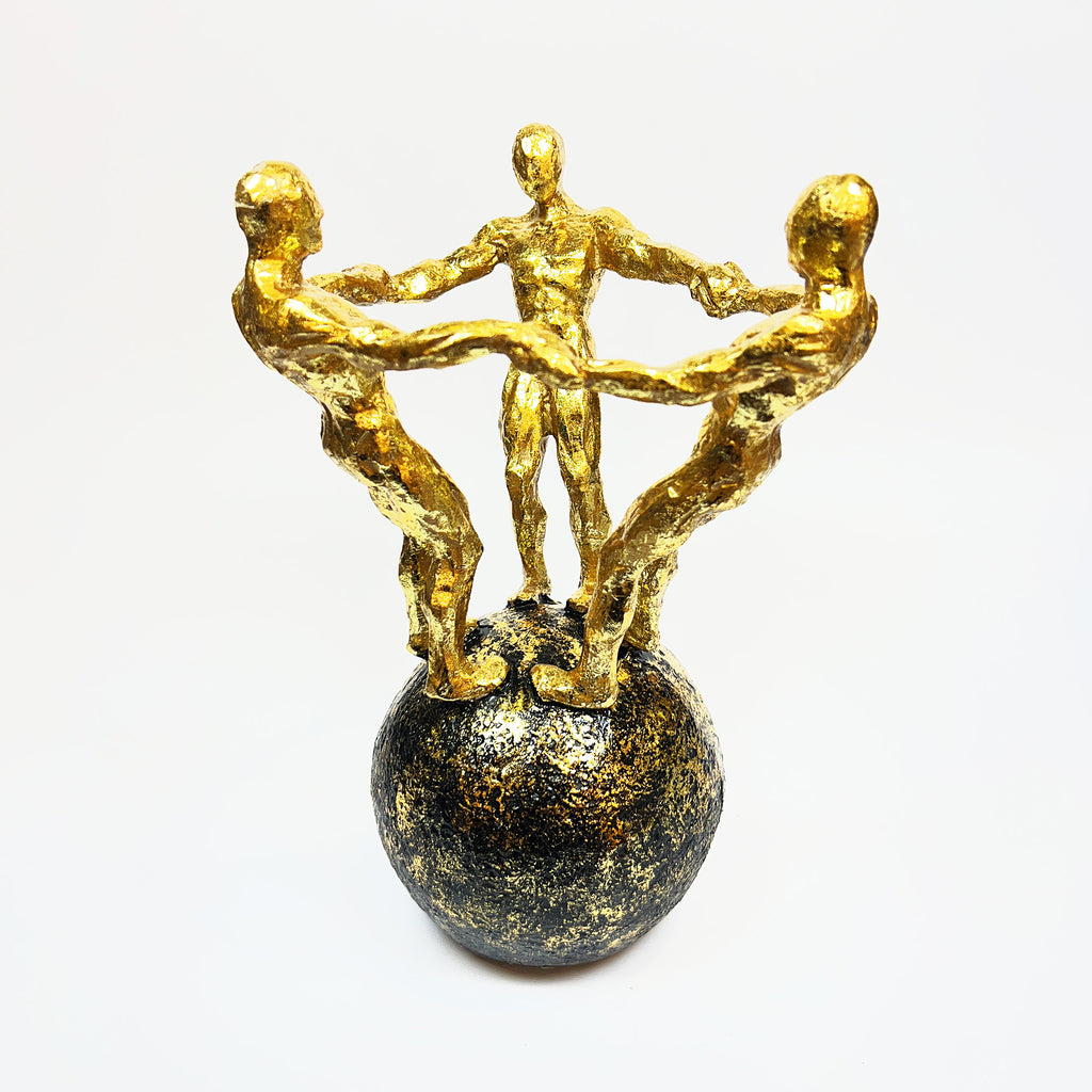 Golden Figurine Trio on Globe