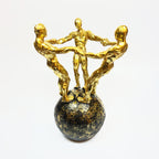 Golden Figurine Trio on Globe