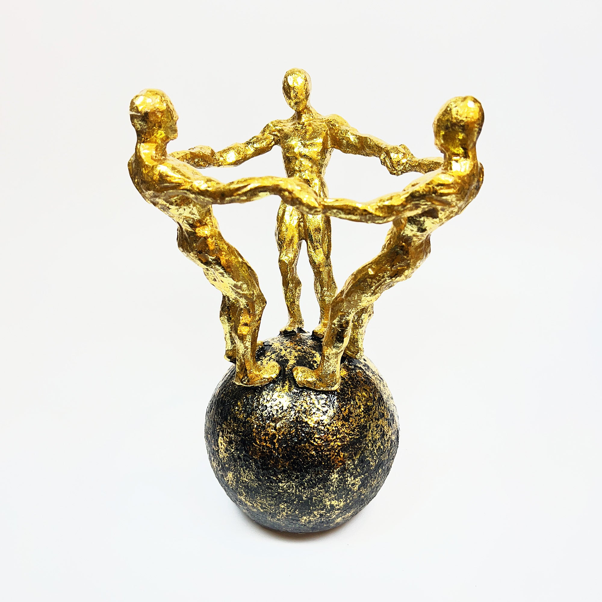 Golden Figurine Trio on Globe