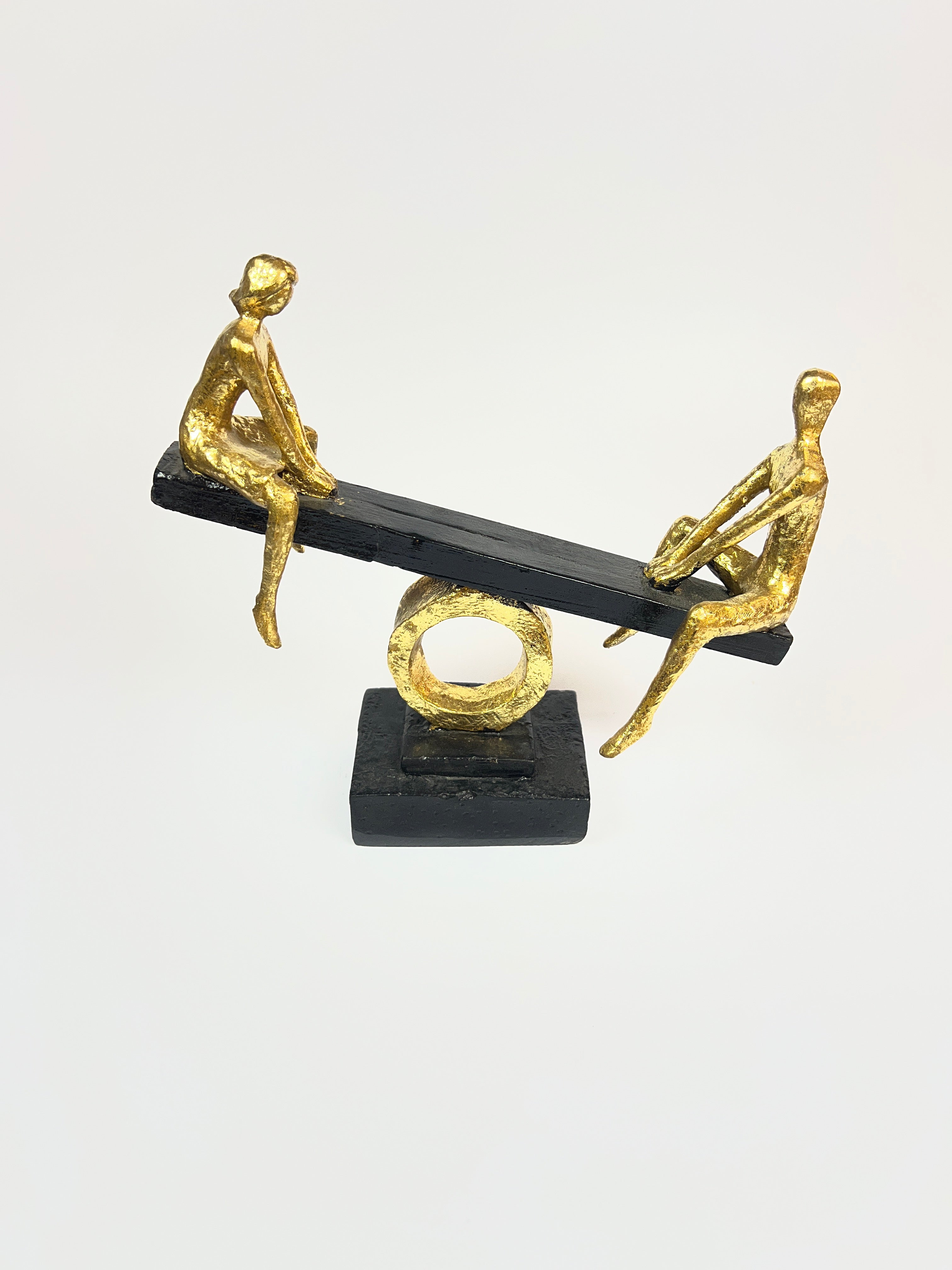 Abstract Figures on Seesaw Sculpture | Gold and Black Fiber Art
